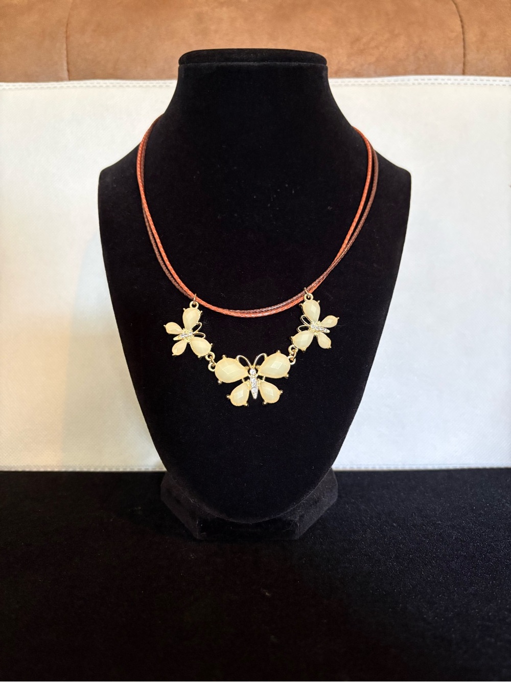 Gold Butterfly Pendant on a Double Leather Cord Necklace